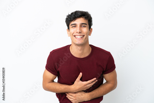 Young Argentinian man isolated on white background smiling a lot © luismolinero