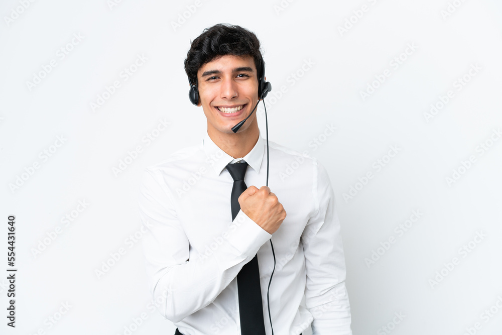 Telemarketer man working with a headset isolated on white background celebrating a victory Telemarketer man working with a headset isolated on white background celebrating a victory