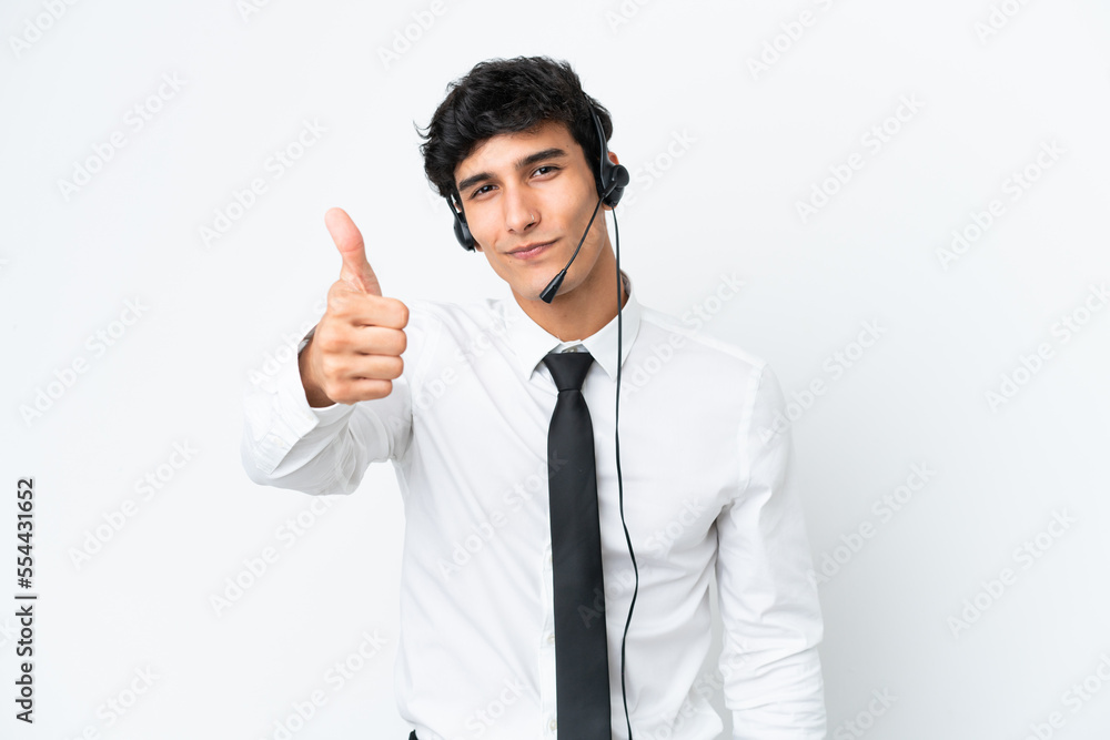 Telemarketer man working with a headset isolated on white background with thumbs up because something good has happened Telemarketer man working with a headset isolated on white background with thumbs up because something good has happened