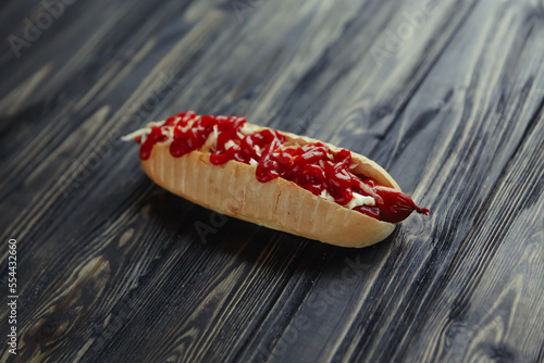 hot dog with vegetables on wooden background.photo with copy space