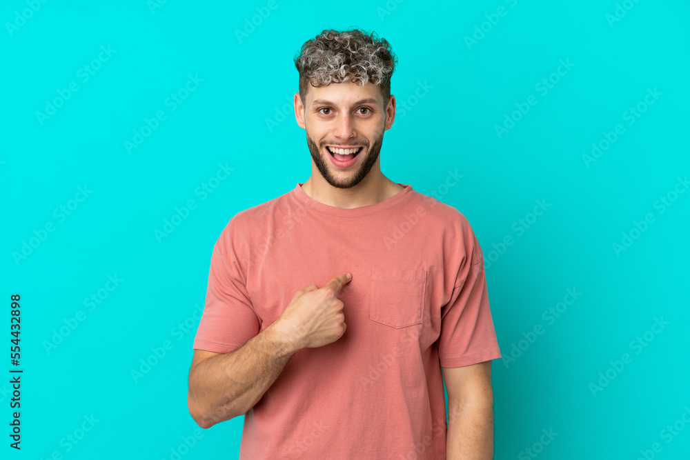 Young handsome caucasian man isolated on blue background with surprise facial expression Young handsome caucasian man isolated on blue background with surprise facial expression