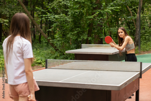 Принти на полотні ping pong outdoor, teenager girls playing table tennis with table tennis rackets