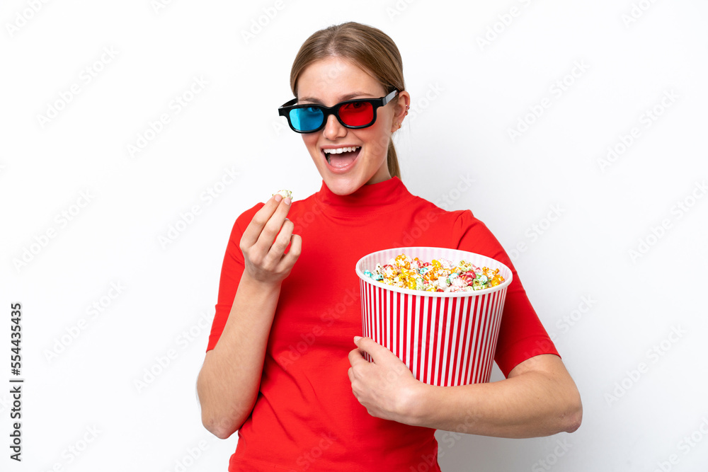 Young caucasian woman isolated on white background with 3d glasses and holding a big bucket of popcorns