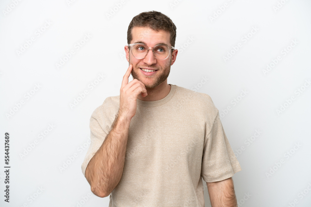 Young caucasian man isolated on white background thinking an idea while looking up Young caucasian man isolated on white background thinking an idea while looking up