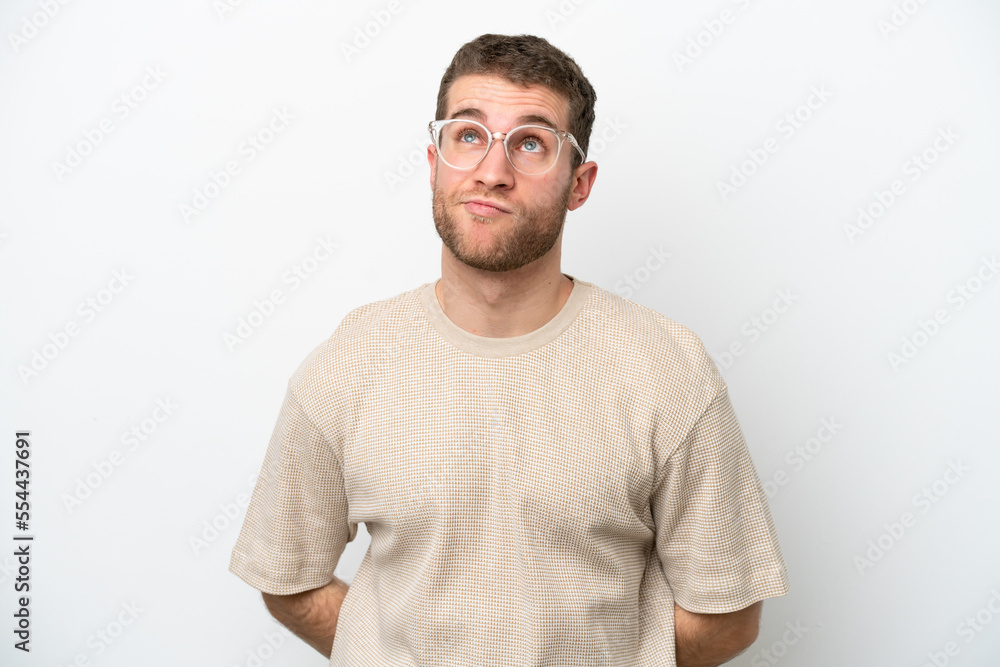 Young caucasian man isolated on white background and looking up Young caucasian man isolated on white background and looking up