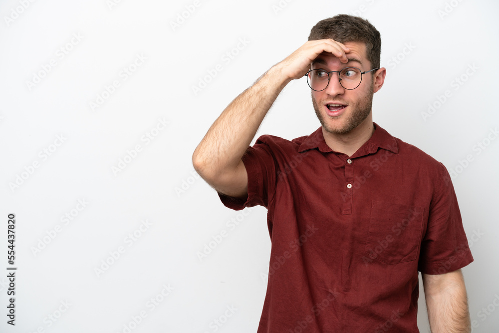 Young caucasian man isolated on white background doing surprise gesture while looking front Young caucasian man isolated on white background doing surprise gesture while looking front