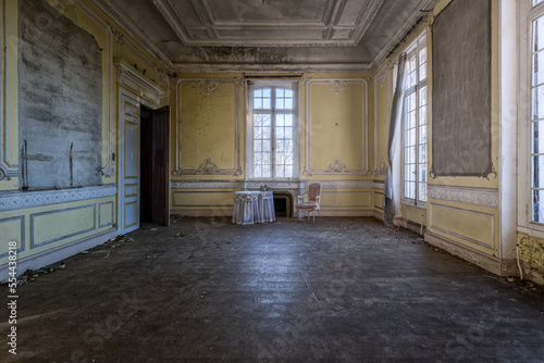 Room of an abandoned building with only a table and a chair. Chateau Cinderella