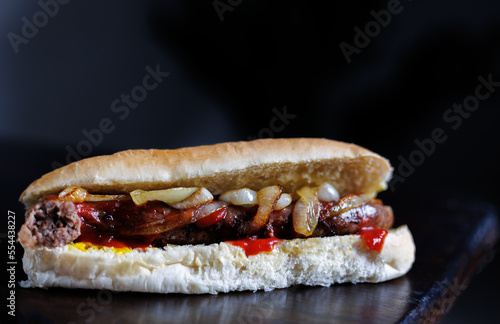 close up of boerewors roll with onions and tomato sauce