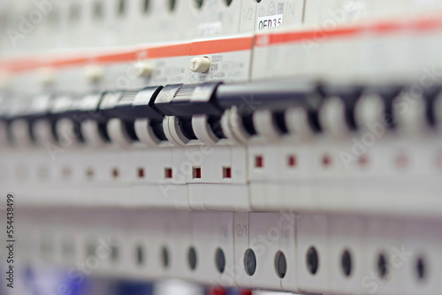 Switched on current circuit breakers to protect electrical wires on the production process control panel.