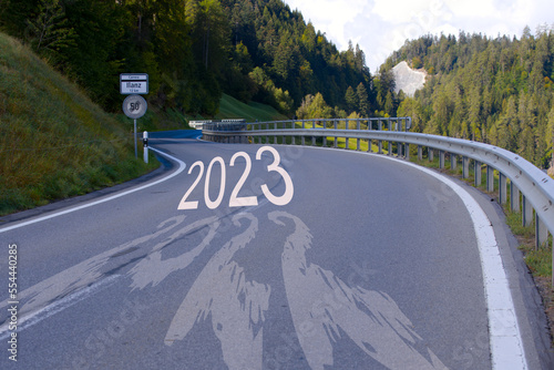 Year 2022 passing and New Year 2023 arriving on main road at Versam, Canton Graubünden, on a sunny autumn day. Photo collage made October 5th, 2022, Zurich, Switzerland. photo