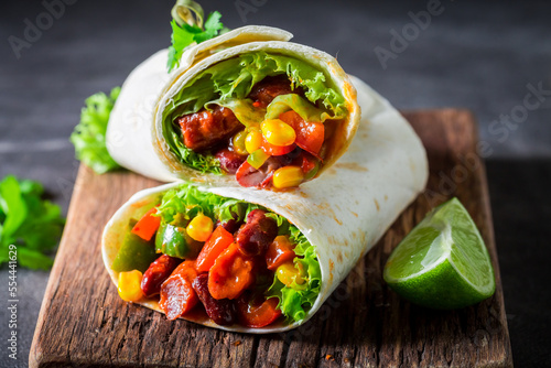 Spicy and hot burrito with vegetables and lime.