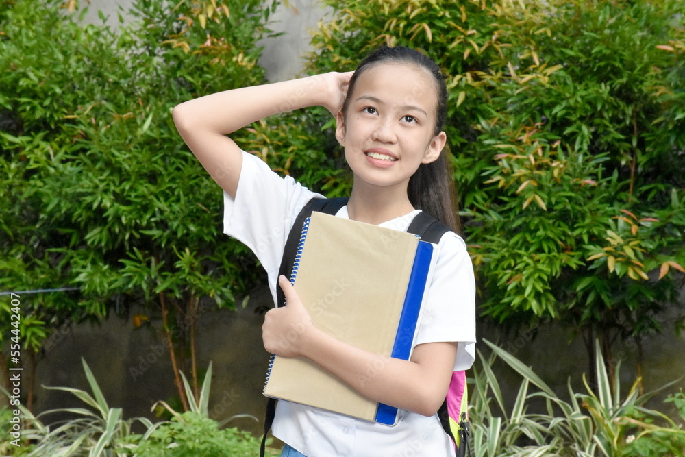 Youthful Filipina School Girl Posing With Textbooks Youthful Filipina School Girl Posing With Textbooks