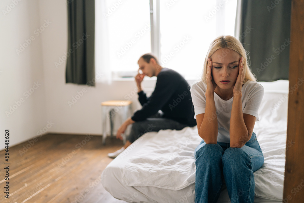 Sad depressed stubborn couple sitting separate on bed turn back ignore each other after fight. Angry man and upset woman not talking showing selfishness in bad relationship. Concept of family problems Sad depressed stubborn couple sitting separate on bed turn back ignore each other after fight. Angry man and upset woman not talking showing selfishness in bad relationship. Concept of family problems