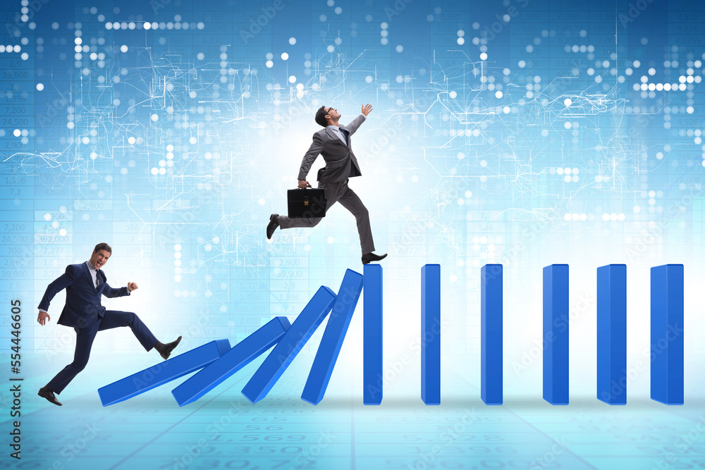 Businessman in domino effect concept Businessman in domino effect concept