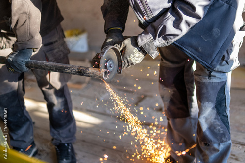 Man cutting a metal gas pipe