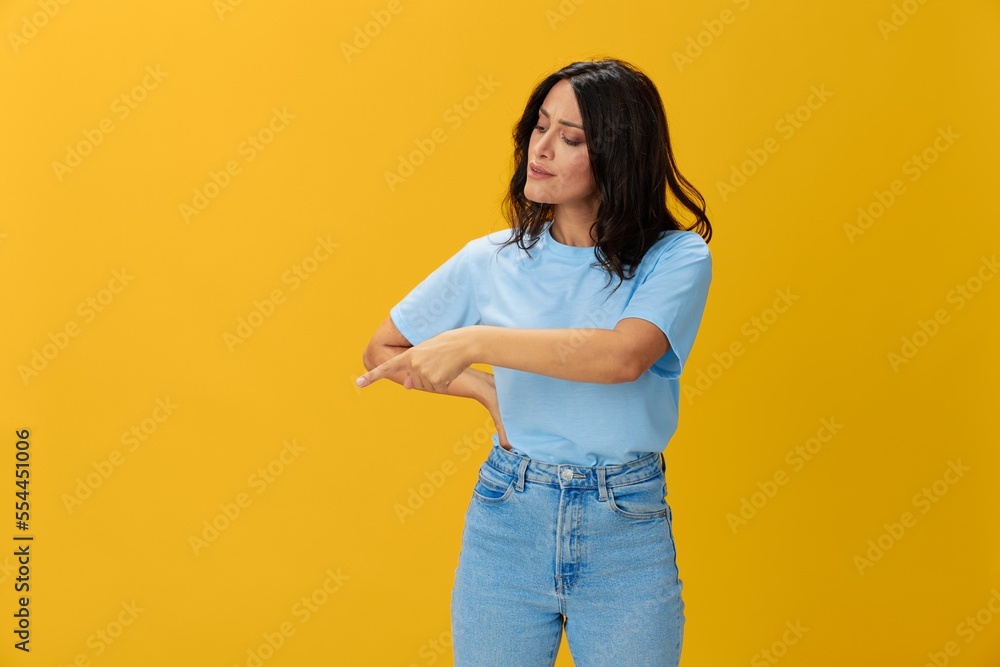 Woman signal smile with teeth emotion portrait in blue t-shirt on yellow background, hands up, surprise, lifestyle, copy space Woman signal smile with teeth emotion portrait in blue t-shirt on yellow background, hands up, surprise, lifestyle, copy space