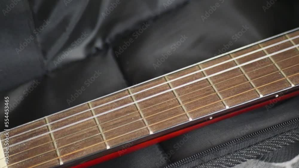 A girl takes a guitar out of the case A girl takes a guitar out of the case