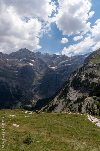 Famous Gavarnie Falls in French Pyrenees, the highest waterfall in mainland France. View from Plateau de Bellevue, with green meadows in foreground.