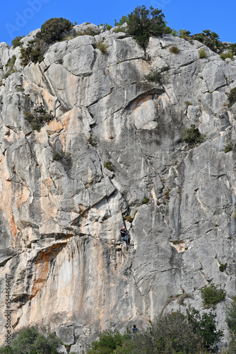 Limestone mountain with climber (Garraf, Barcelona, Spain).