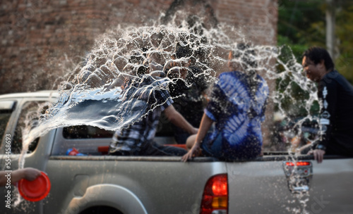 Water is splashing to people on a car in Songkran festival, Chiangmai, Thailand