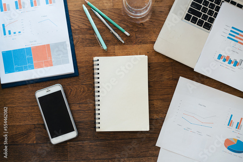 Non people imagery of desk set-up , work environments . work at a desk in a home office. .Writing on a notepad while working from home.