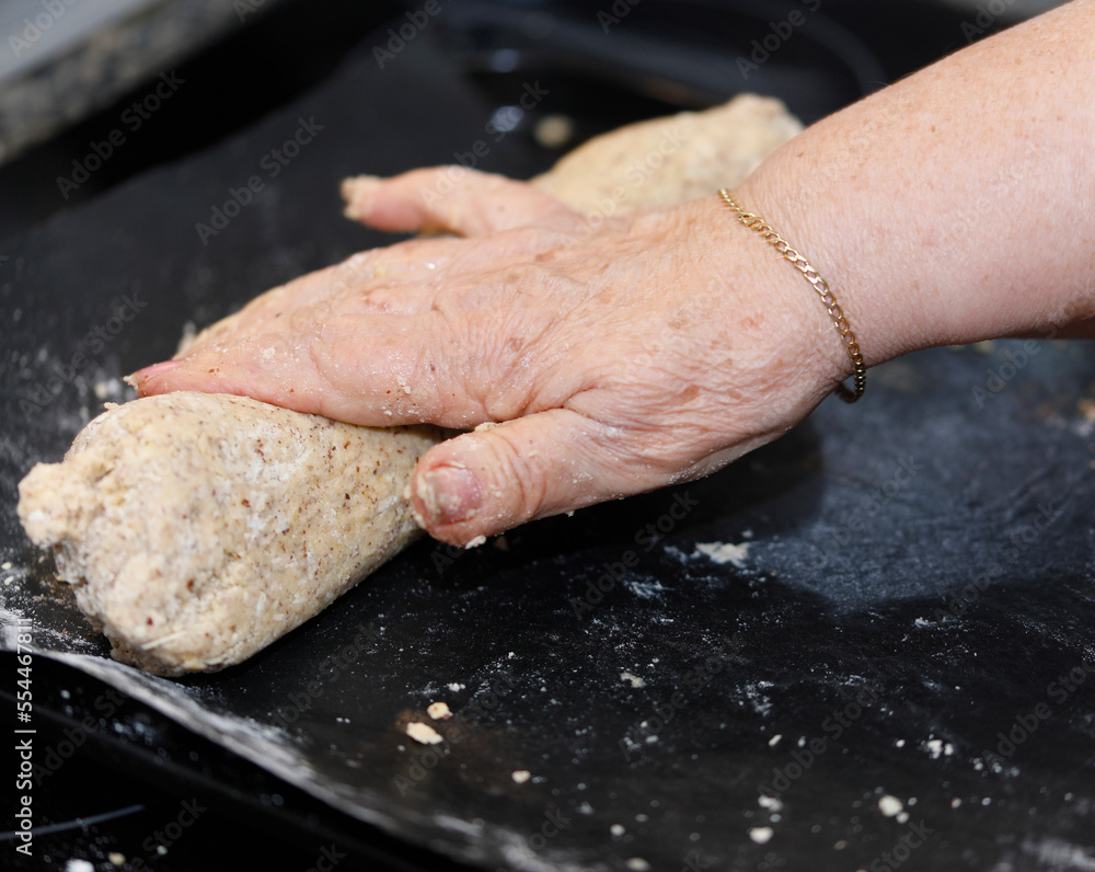 A woman is baking vanilla-flavoured crescent cookies A woman is baking vanilla-flavoured crescent cookies