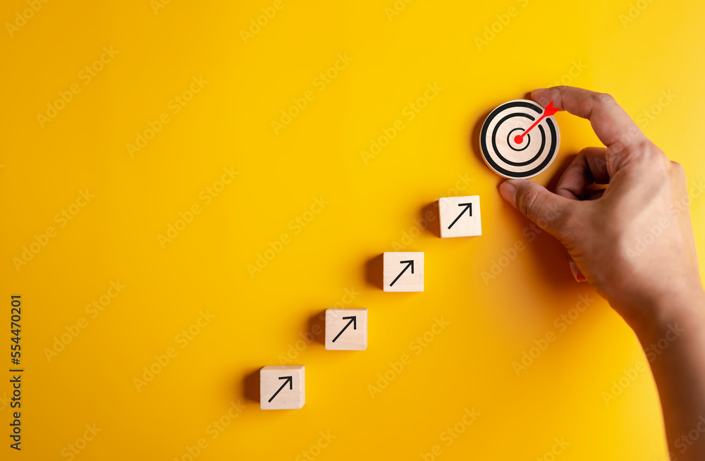 Business growth success achievement concept, hand arranging wooden block stacking as step stair or ladder for planning development leadership and customer target group concept.. - obrazy, fototapety, plakaty 