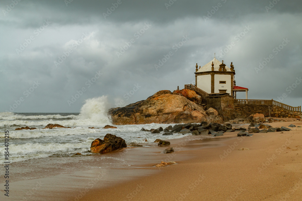 small chapel at the atlantic in stormy weather