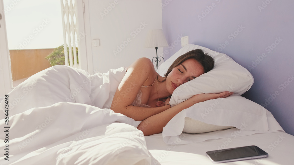 Young woman sleeping in bed early in the morning Young woman sleeping in bed early in the morning