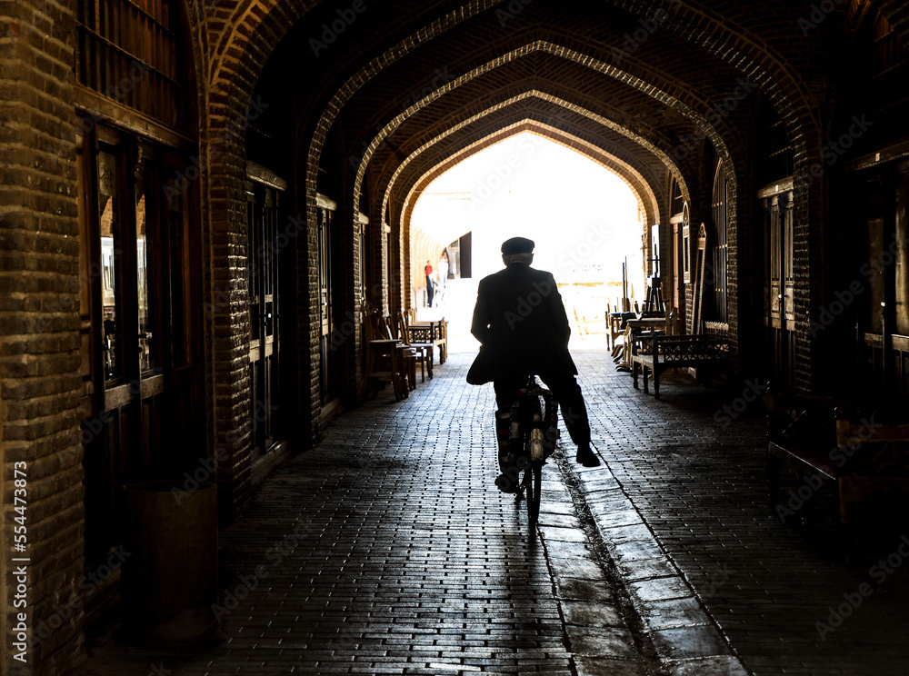 silhouette of a person walking in a tunnel