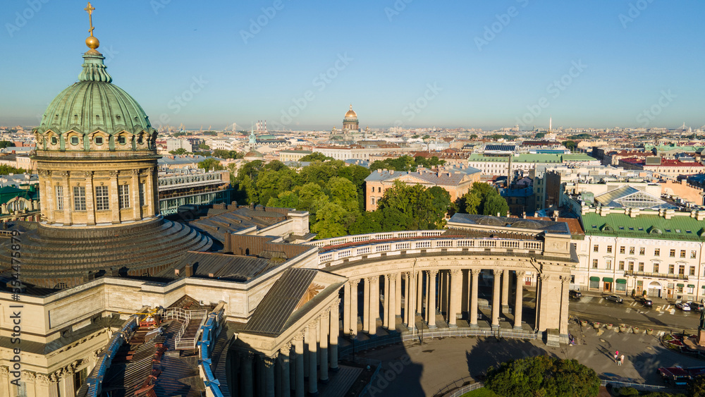 Aerial view of the Nevski street and Kazan Cathedral in the historical and at same time modern city of St. Petersburg at sunny summer dawn, gold