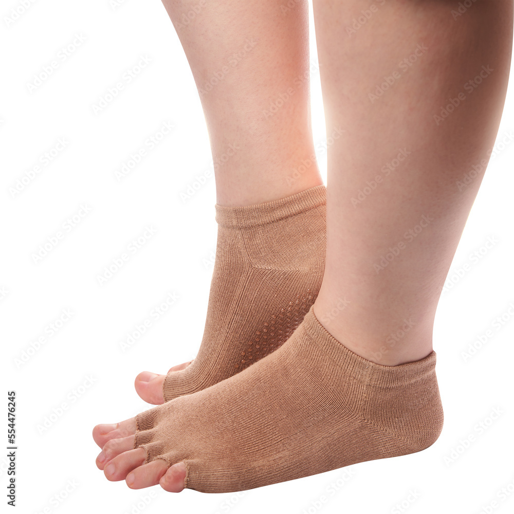 Isolated close-up woman wearing yoga socks with open toes Isolated close-up woman wearing yoga socks with open toes
