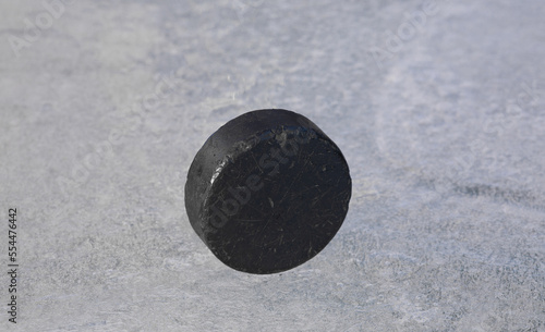 black hockey puck on ice