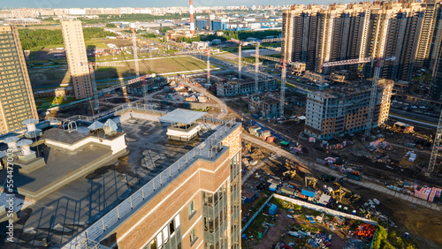 Aerial view of a residential high-rise buildings and constructing more next to park and highway in the historical and at same time modern city of St. Petersburg at sunny summer day