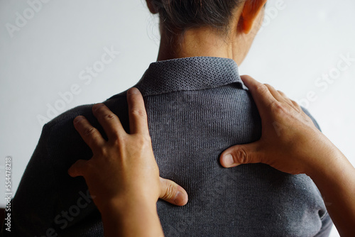 Closeup hands massage woman's shoulders. Concept, healthcare. Elderly health problem, backache and shoulder ache. Massage to relief syndrome. Body therapy treatment. Physiotherapy. 