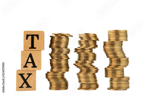 word tax in wooden blocks and stacked gold coins on white background