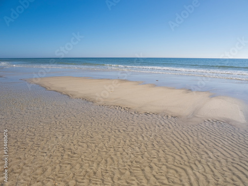 Fototapeta Naklejka Na Ścianę i Meble -  Calm blue sky summer  day on the Gulf of Mexico beach on St George Island in the panhandle or Forgotten Coast area of Florida in the United States