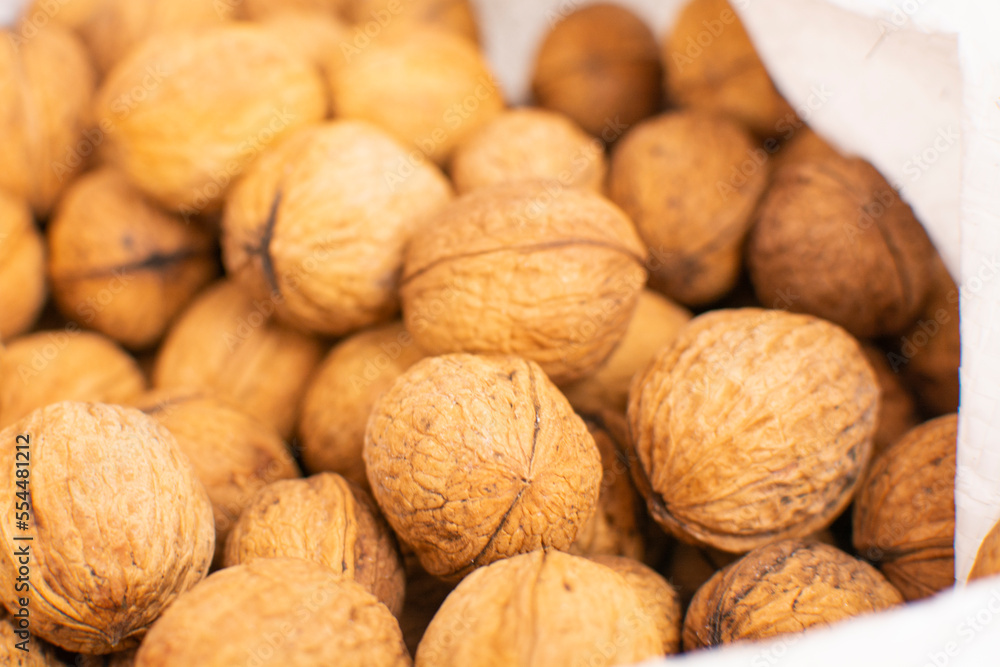 Walnuts with shells. Background of fresh walnuts. Walnuts with shells. Background of fresh walnuts.