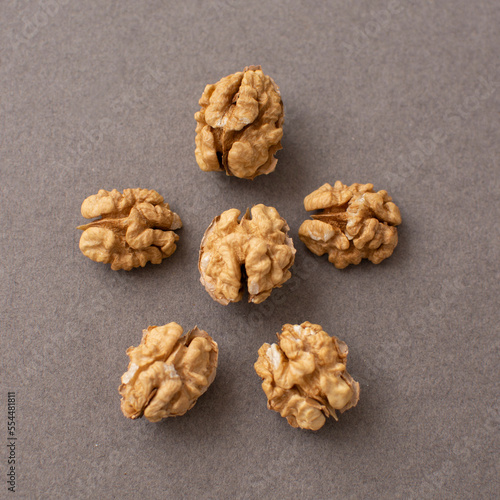 Walnut kernels on a gray background. Peeled walnut