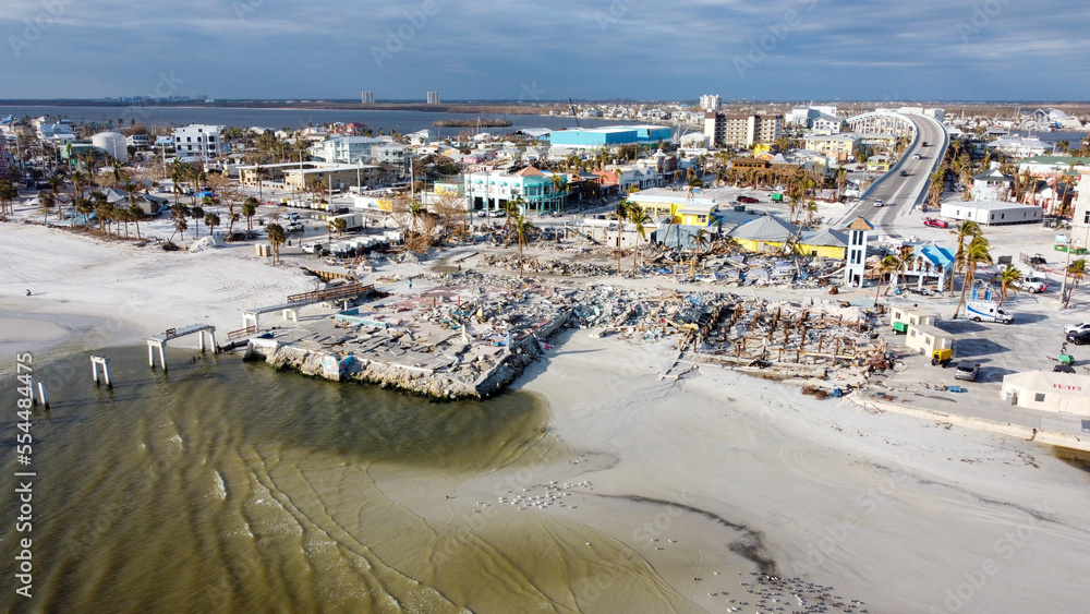 A month after Hurricane Ian brought historic winds and storm surge to the island of Fort Myers Beach, rubble still sits in piles near the shore. 