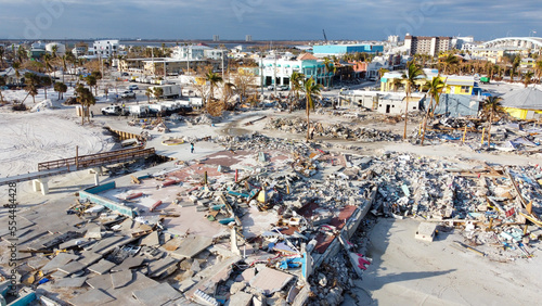 A month after Hurricane Ian brought historic winds and storm surge to the island of Fort Myers Beach, rubble still sits in piles near the shore.  photo