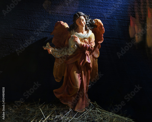 wax Christmas figurine of Gloria Angel on a dark background