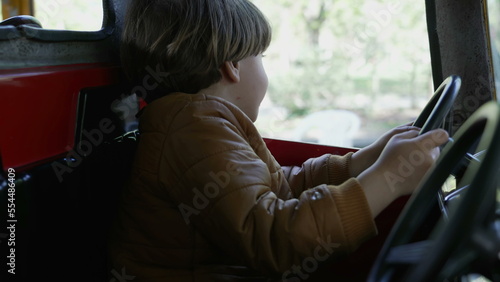 Εκτύπωση καμβά One happy small boy driving toy car interior at amusement park carousel