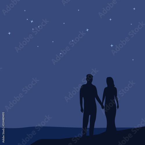 Silhouette of a couple standing under the stars at night