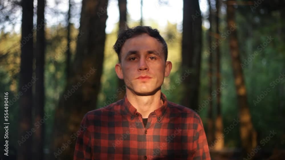 Portrait of a guy in nature. A guy in the summer in a shirt. Light on a man's face. Portrait of a guy in nature. A guy in the summer in a shirt. Light on a man's face.