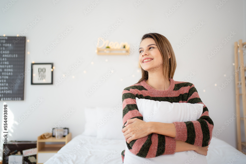 Happy - cheerful beautiful girl in a bedroom decorated in Christmas theme. Happy - cheerful beautiful girl in a bedroom decorated in Christmas theme.