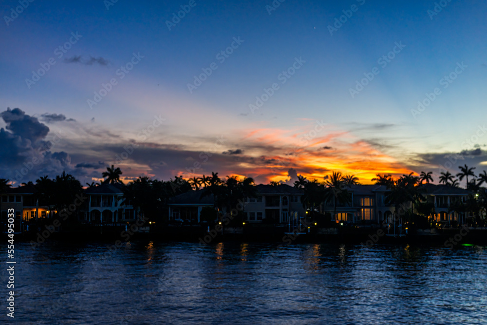 Hollywood beach Miami, Florida Intracoastal water canal Stranahan river and view of waterfront property modern mansions villas houses at beautiful dark red sunset