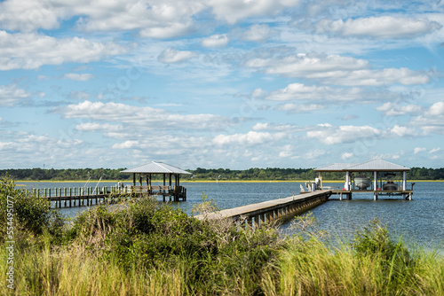 Island bay channel water of Matanzas River in Crescent Beach by Marineland, Florida with wooden docks pier and green grass marsh landscape view in north Florida coast photo