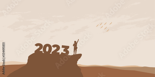 New Year 2023 concept. Man meets dawn in mountains for new year 2023. New Start motivation inspirational quote message on silhouette man