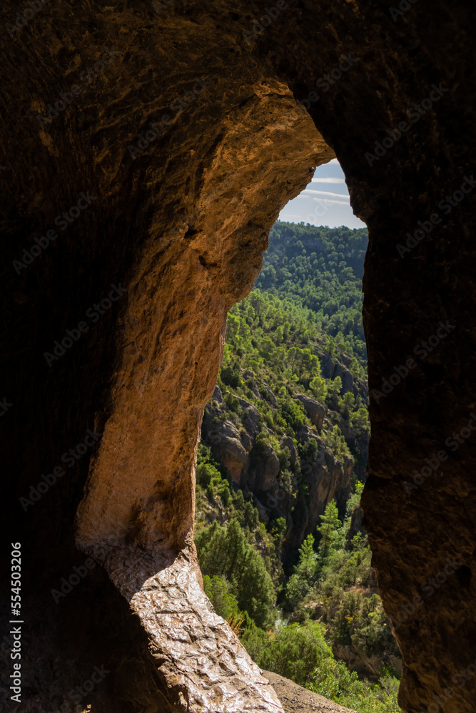 Tunnel excavated in the rock on the route of the Peña Cortada aqueduct in Calles. Valencia Spain